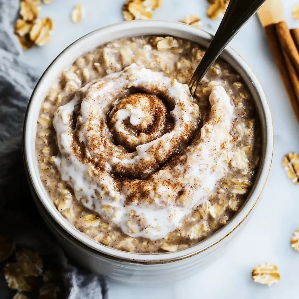 A bowl of oatmeal with a spoon in it.
